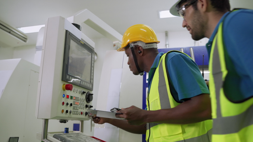 African worker The American and the Caucasian engineers were helping to checking  the machines in the factory
 | Shutterstock HD Video #1065538774
