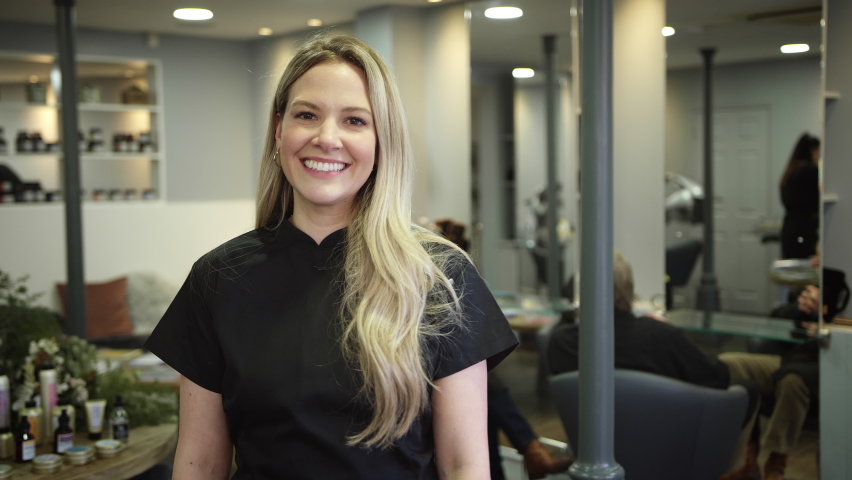 Portrait of smiling female stylist or business owner in hairdressing salon - shot in slow motion | Shutterstock HD Video #1065539929