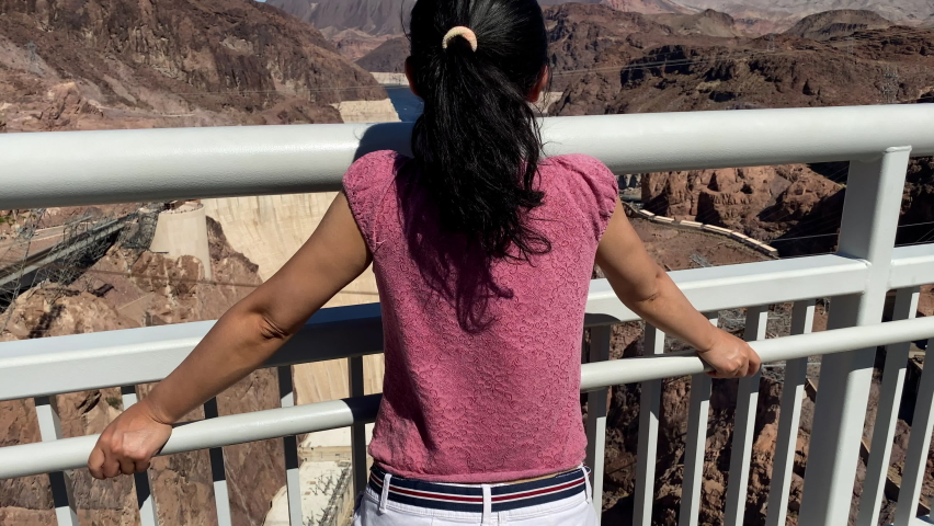 Asian woman enjoys the view of Hoover Dam on the border of Nevada and Arizona.