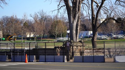 Washington, DC, USA - January, 12, 2021: 7-foot fence around US Capitol and National Guard members supporting security before inauguration. 