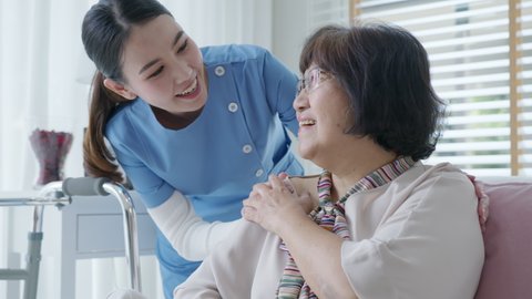 Young asian woman or nurse home care hand on senior grandmother shoulder give support empathy to elderly lady or older people in assisted living homecare mental health sick relief concept.