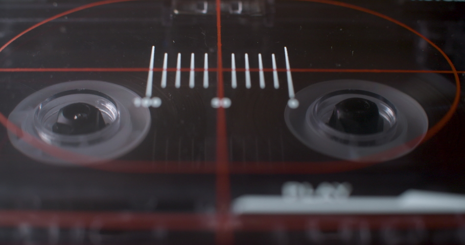 Cassette Deck, Ominous. A light dramatically sweeps across a macro close up of an old audio cassette player. | Shutterstock HD Video #1065547336