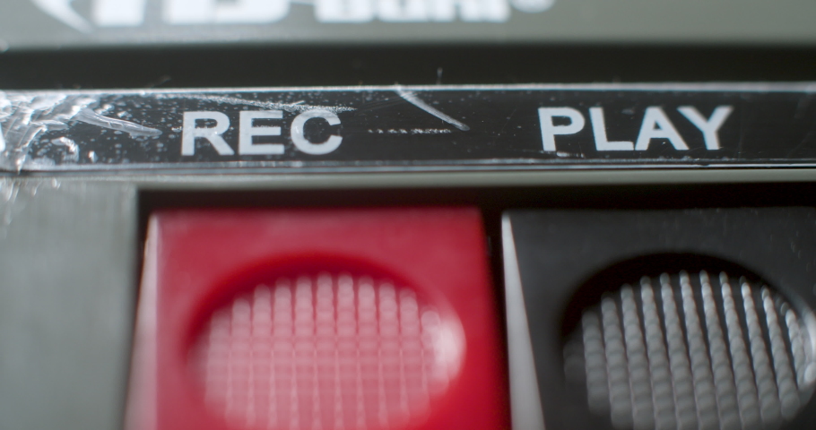 Press Record Button, Macro. A macro close up of the play-record buttons being pressed on an old audio cassette player. | Shutterstock HD Video #1065547366