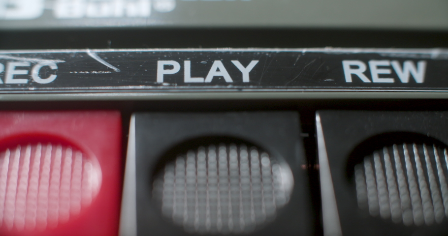 Press Play Button, Macro. A macro close up of the play button being pressed on an old audio cassette player. | Shutterstock HD Video #1065547375
