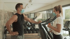 Young athlete woman and man with face mask talking in the gym. Sport during the COVID-19 pandemic. - Powered by Shutterstock - Get 15% off with code: PIKWIZARD15