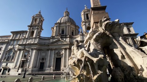 The fountain of the four rivers with the facade of the church of Santa Agnese in Piazza Navona in Rome. Town square. Baroque art. Tourism and travel