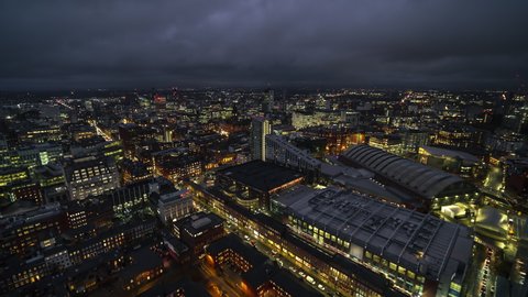 Establishing Aerial View Shot of Manchester UK, Capital of North, City Skyline, England, United Kingdom night evening push back