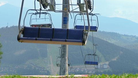 Long cable car line and ski lift working on top of the mountain. Concept of travel and tourism in mountain at summer.