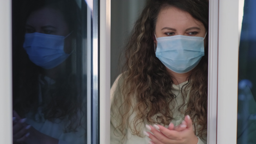 Woman applauding from window to support medical staff, health workers, doctors, nurses during Coronavirus pandemic. Stay home, quarantine.