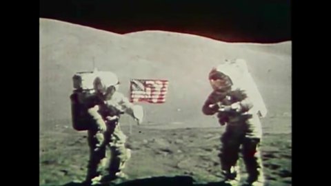 CIRCA 1969 - Astronauts Buzz Aldrin and Neil Armstrong plant the American flag on the moon.
