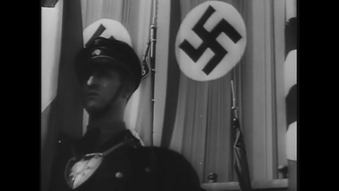 CIRCA 1940s - Adolf Hitler addresses an enormous crowd at an outdoor Nazi rally.