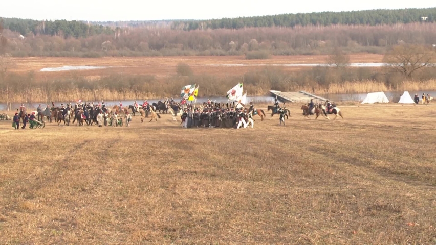 Reconstruction of the battle of 1812, the Russian army attacks the French near the Berezina River, soldiers fire cannons and rifles, cavalry gallops, Belarus, the General plan,