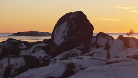 Winter Sunset Over Sea with Icy and Snowy coastline