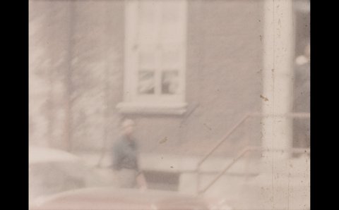 1960s: Man talks to pregnant woman in doorway. Men sit on stoops in city and talk. Woman stands from doorway and enters apartment building. Woman sits on chair outside apartment.