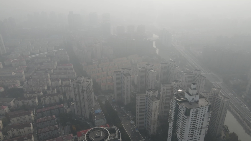 City in heavy haze and air pollution. Building and roads in fog in day time. Environmental conservation and air pollution issues concept b-roll footage. Highly polluted residential area Shanghai China Royalty-Free Stock Footage #1065570217
