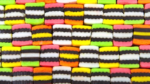 HD video above zooming on background of  bright colorful licorice candy squares alternating colors.
