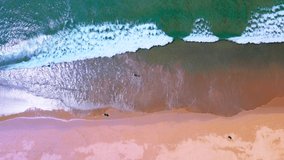 After Covid-19. Aerial view of Video clip Top view Beautiful Beach and seawater surf on sandy. In sunny summer day.