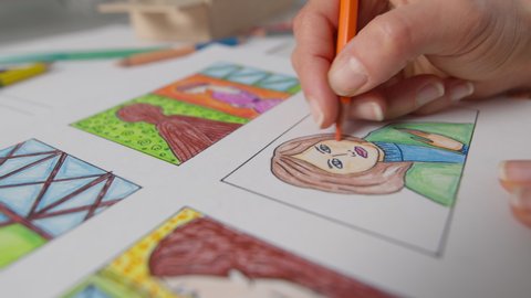 An illustrator painter draws colored storyboards. The artist creates sketches of stories for comics or films.