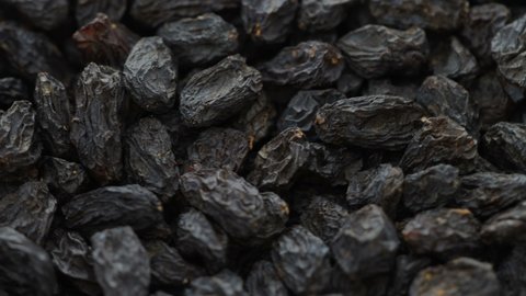 Black dry raisins moving food texture.
