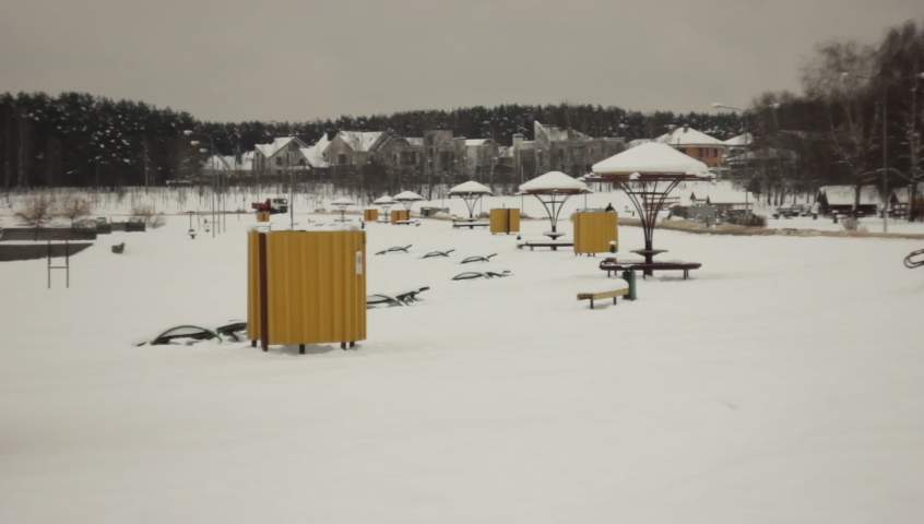 Snowy beach at the lake shore during winter time
