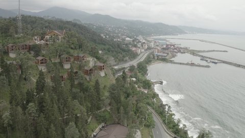 Aerial View of Coastal Highway along Black Sea and Hilltop stunning huts (hotel) overlooking sea Trabzon Turkey. Professional RAW 4k Footage