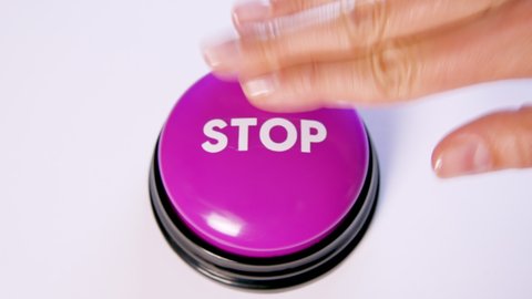 Woman pushing a Stop button, close up. Finger pressing button to pause an action or process. Emergency stop symbol, power off for safety. 