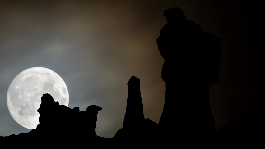 Badlands National Park in USA Time Lapse by Night with Full Moon and Rocks in Silhouette
