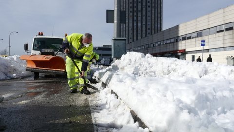 Cleaning workers removing snow next to the University Hospital of La Paz after the snowfall caused by the Filomena storm. Madrid, Spain, January 15, 2021.