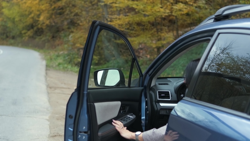 Middle aged pretty woman enjoying time near her vehicle outdoors during road trip. | Shutterstock HD Video #1065626155