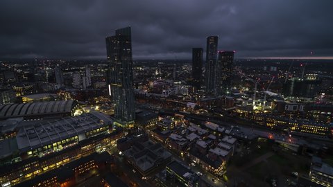 Establishing Aerial View Shot of Manchester UK, Capital of North, City Skyline, busy city, England, United Kingdom night evening