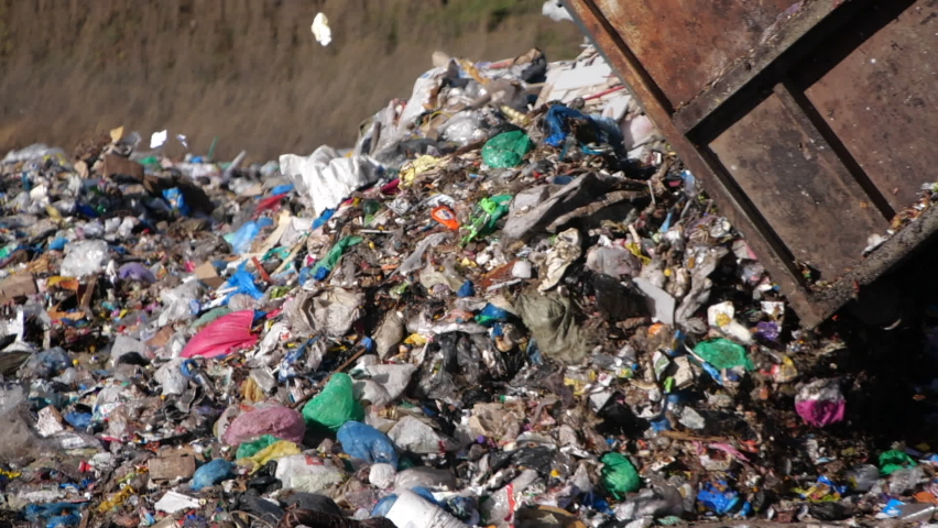 A dump truck unloads a pile of garbage at a landfill in slow motion. Dump of unsorted waste. | Shutterstock HD Video #1065645238