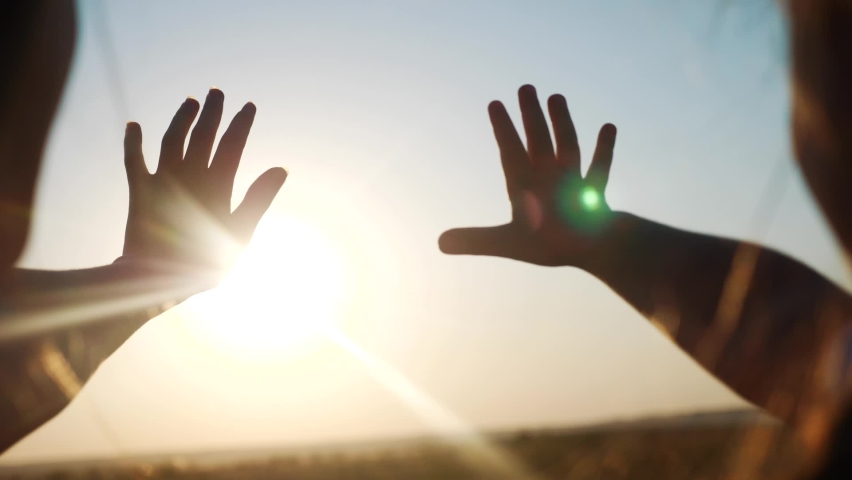 Hands in the sun. mom and daughter hands reach out to the sun silhouette sunlight. happy family kid dream concept. mom and daughter dream of god religion sunset concept | Shutterstock HD Video #1065648898