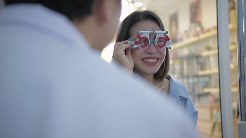 Optical shop concept of 4k Resolution. The ophthalmologist is measuring the customer's eyes. Royalty-Free Stock Footage #1065651358
