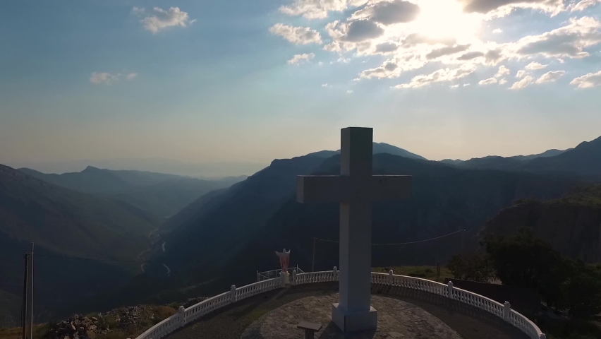 Aerial footage of a large white cross that looks out over the valley.