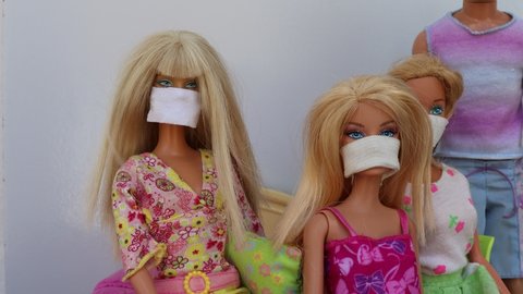 Bahia, Brazil - November 7, 2020. Barbies and Ken dolls wearing protective face masks. COVID-19 concept.
