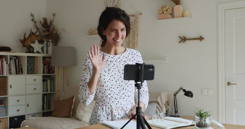 Excited millennial beautiful yoga trainer influencer making namaste sign, waving farewell gesture, asking for supporting and subscribing to personal channel, finishing recording educational video.