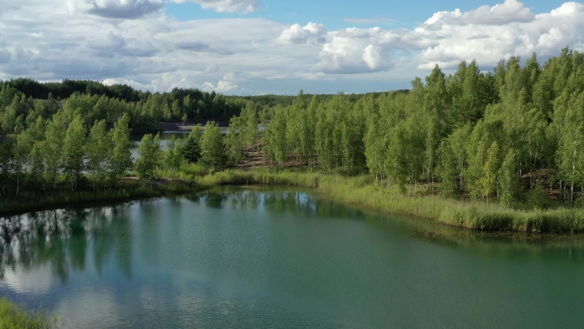Aerial view of an abandoned quarry and the lake with turquoise water.