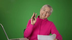 Green screen, chroma key background with business woman smiling talking and looking at camera, webcam point of view in home. Happy teacher doing video chat.