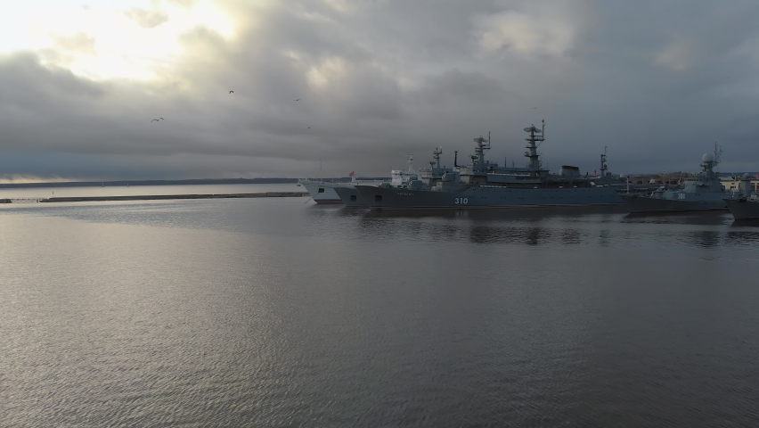 Cruisers and ships in the harbor, Russian Navy, Kronstadt, St. Petersburg, Russia. Aerial panoramic view of old russian city. View from the Drone, Flying over Point of interest	
