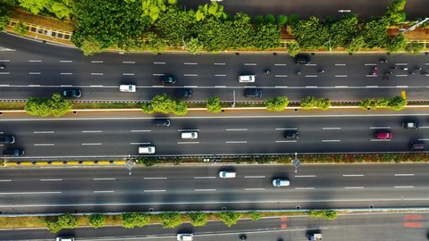 Aerial drone view of highway multi-level junction road with moving cars at sunset. Cars are moving on a multi-level road junction The concept of the urban. Suzhou city, China.