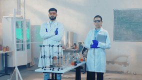 Biotechnology laboratory portrait of a standing two scientist in front of the camera with protective uniform and looking straight - Powered by Shutterstock - Get 15% off with code: PIKWIZARD15