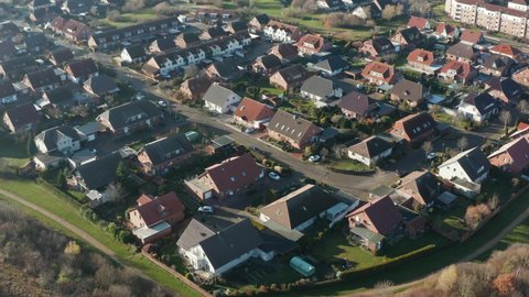 POV from flight over a monotonous settlement with single family houses and row houses in Germany, aerial view