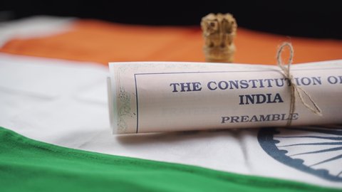 Pan view of Indian constitution or Bharatiya Savidhana preamble placed on Indian flag Concept of Freedom, Nationality and patriotism.