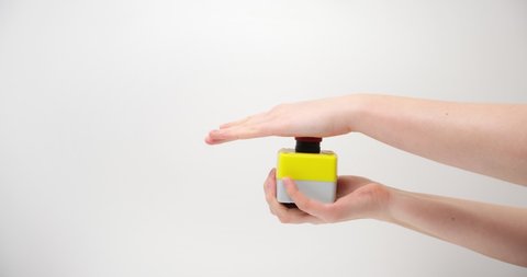 The female hand presses the red button on a light background