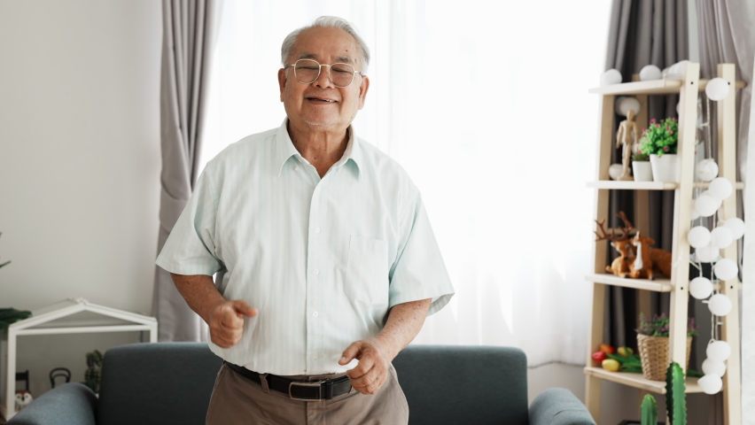 Happy senior dancing happily to show good health in old age. Portrait of elderly man dancing happily for celebrates himself without disease during old age. Royalty-Free Stock Footage #1065709864