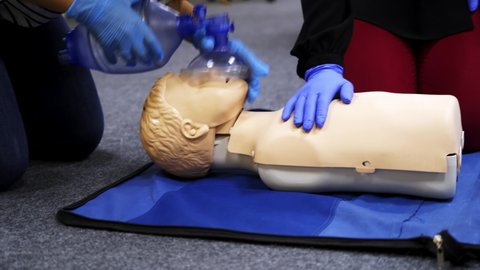 Training compression on a dummy. CPR exercise on a mannequin in the medical center. Teaching skills during heart attack.