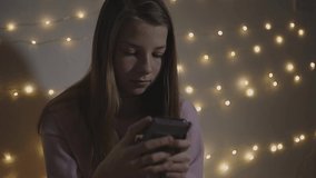 a teenage girl prints text on a smartphone, correspondence with her friends on social networks, communication between teenagers