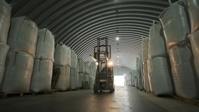 Warehousing. Forklift driver stacking big bag of raw material in warehouse. Many bags of raw materials in the warehouse - Powered by Shutterstock - Get 15% off with code: PIKWIZARD15