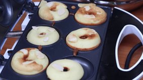Footage of taking donuts out of mini donut maker. Easy dessert recipes to make at home while social distancing in the COVID-19 outbreak. 