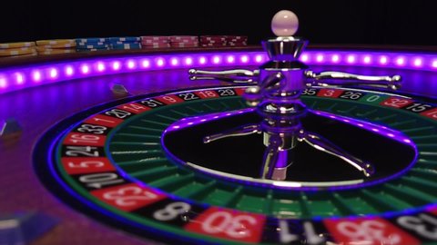 Close up slow motion of a spinning roulette wheel at the casino table